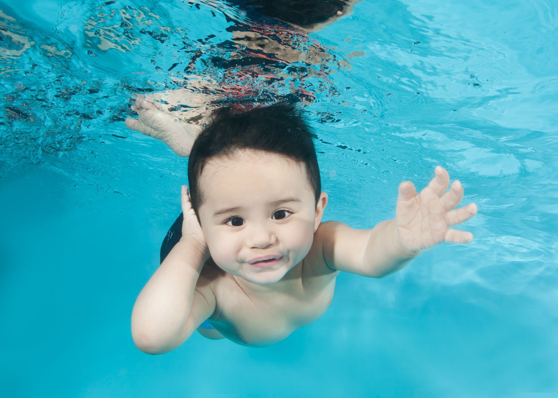 Underwater Young Boy Fun in the Swimming Pool with Goggles. Summer Vacation Fun