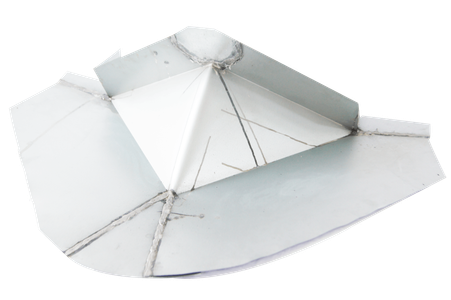 A white paper boat is sitting on a white surface.