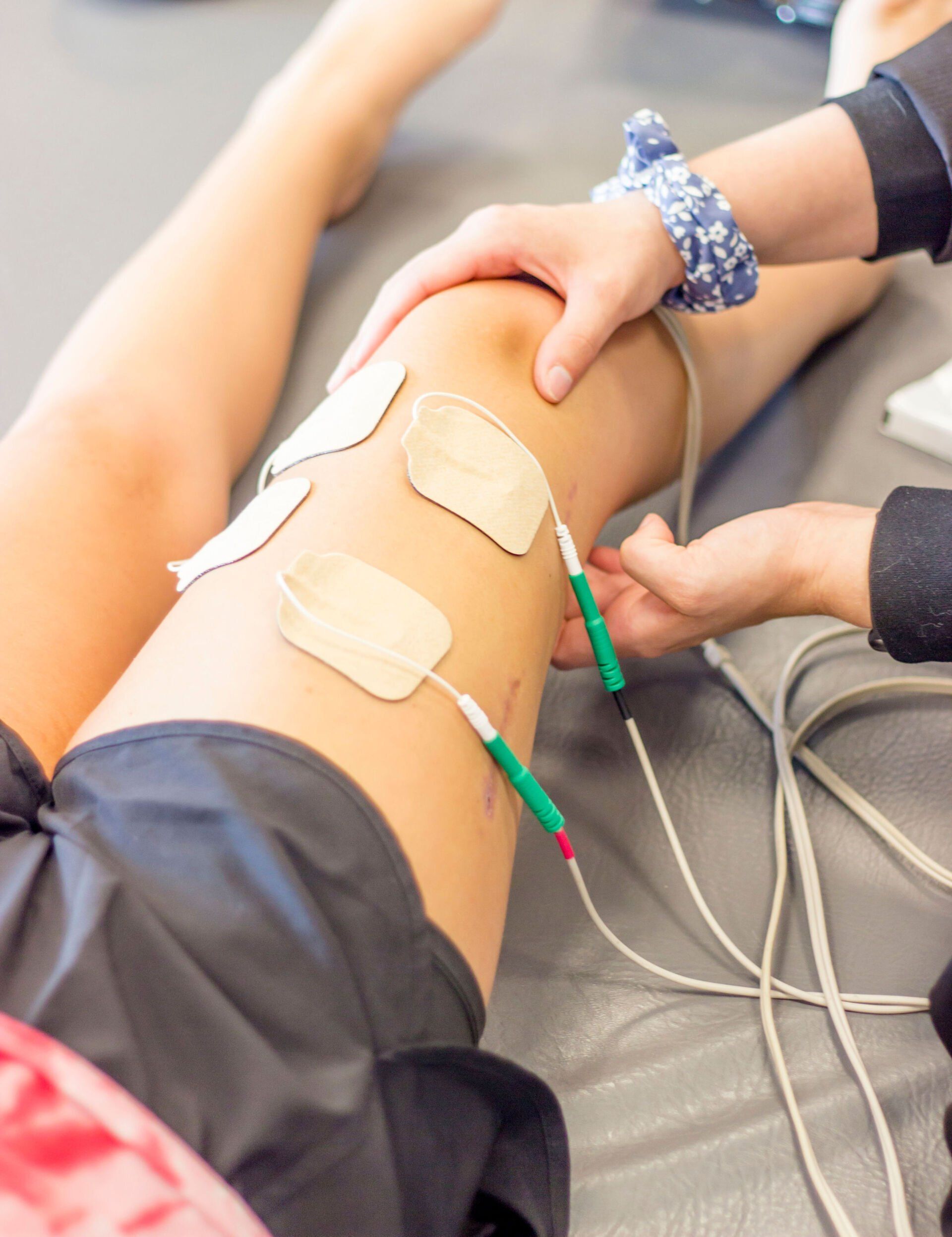 Person having ECG electrodes attached to a leg during a medical procedure