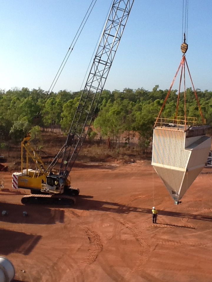 A Large Crane Is Parked On A Construction Site At Sunset — J & D Rigging Pty Ltd In Bohle, QLD