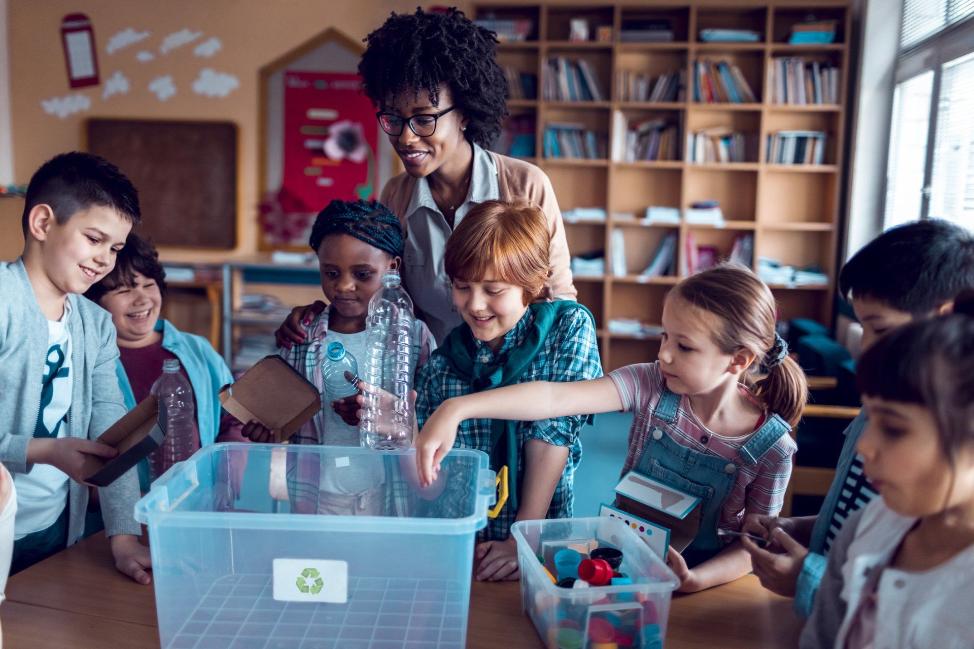 Close up of a teacher and kids in the classroom — Verona, WI — Once Upon a Time Childcare Center Close up of a teacher and kids in the classroom — Verona, WI — Once Upon a Time Childcare Center