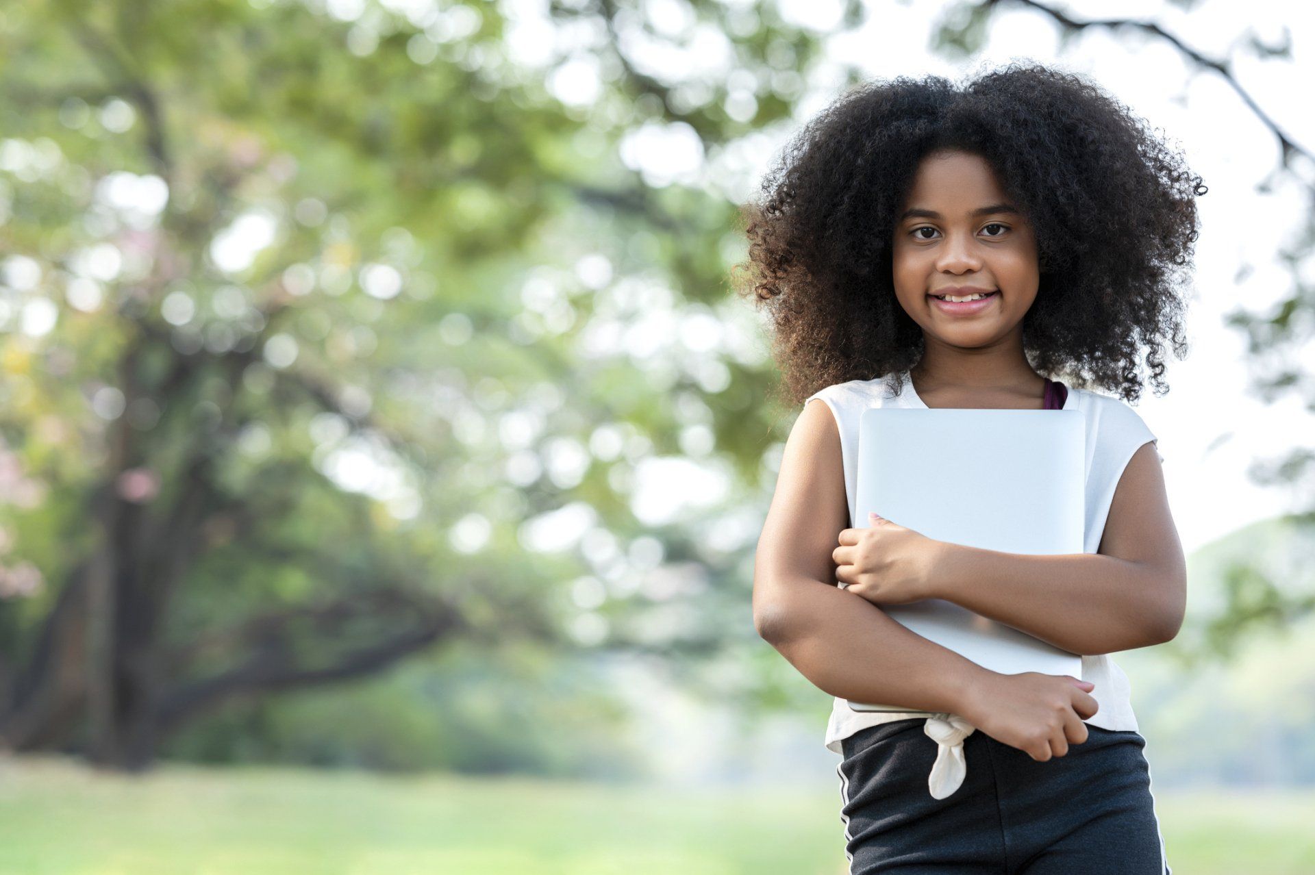 Pretty girl holding a book — Verona, WI — Once Upon a Time Childcare Center
