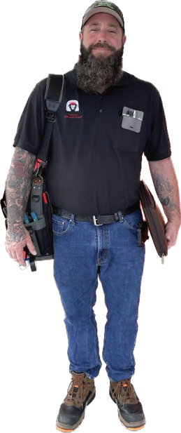 Full-length man in a black polo, jeans, and work boots, holding a folder against a white background