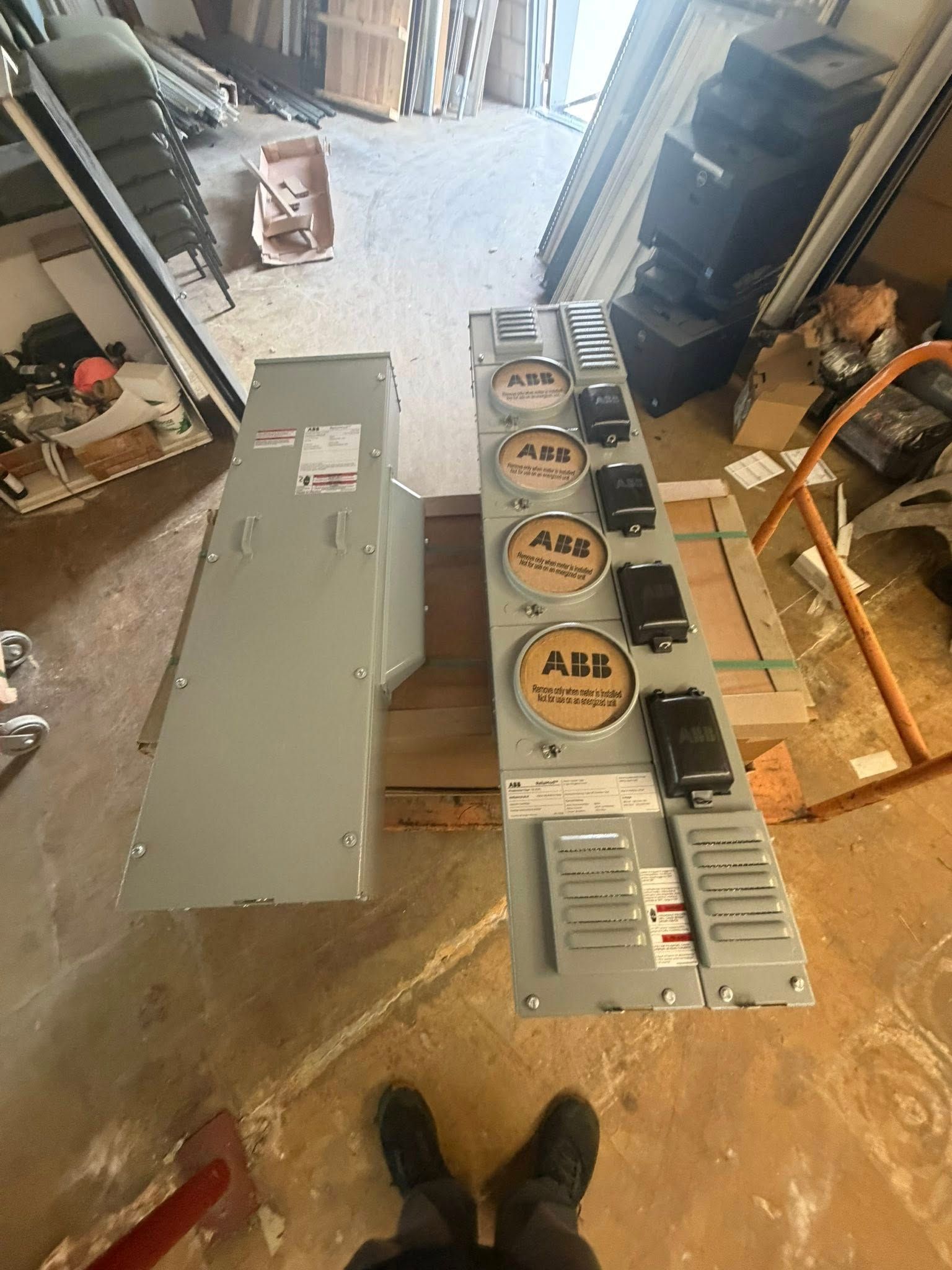 Open metal HVAC cabinet and parts laid out on a workshop floor.
