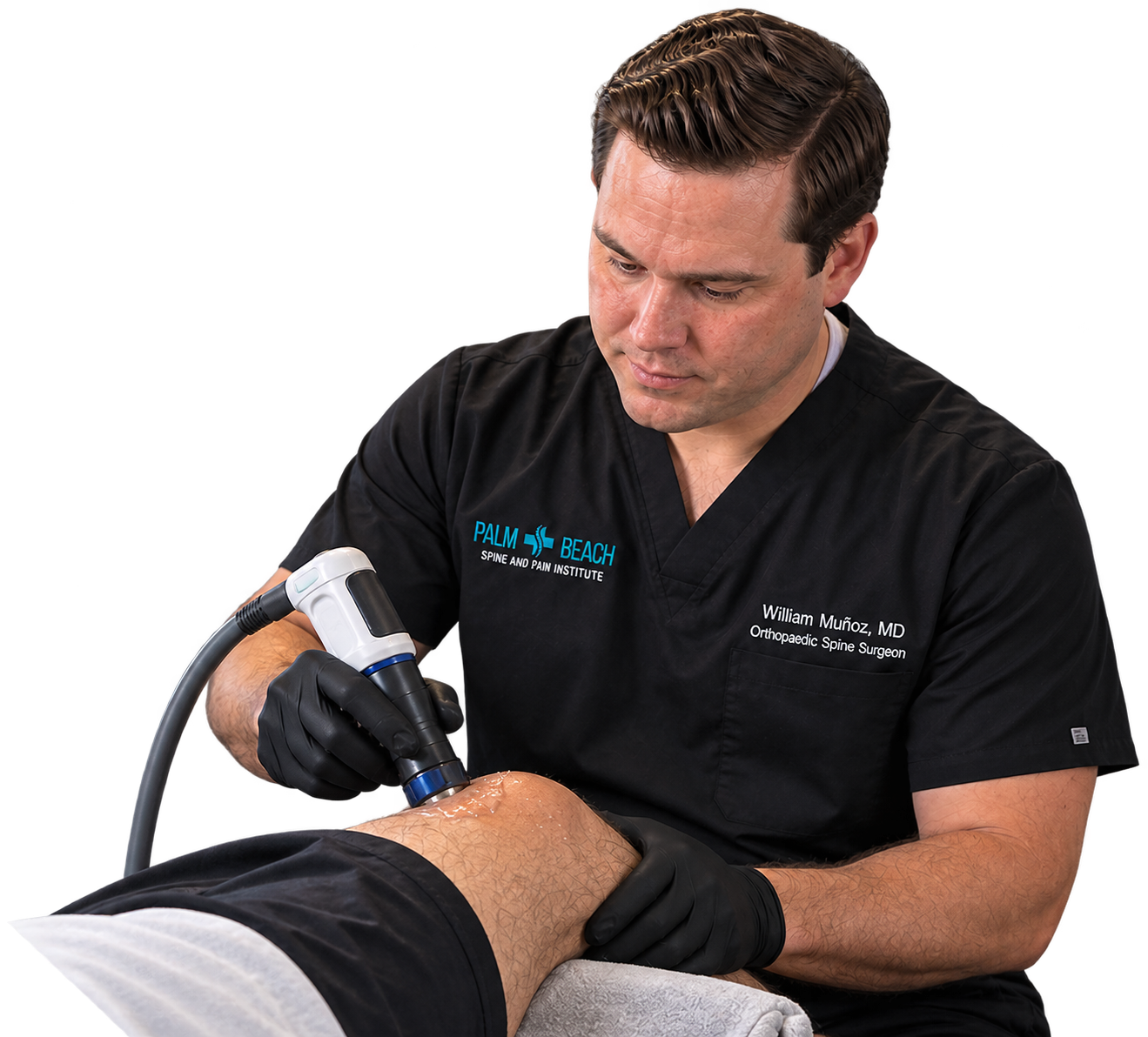 Clinician using handheld device to treat patient’s bent knee in a medical setting