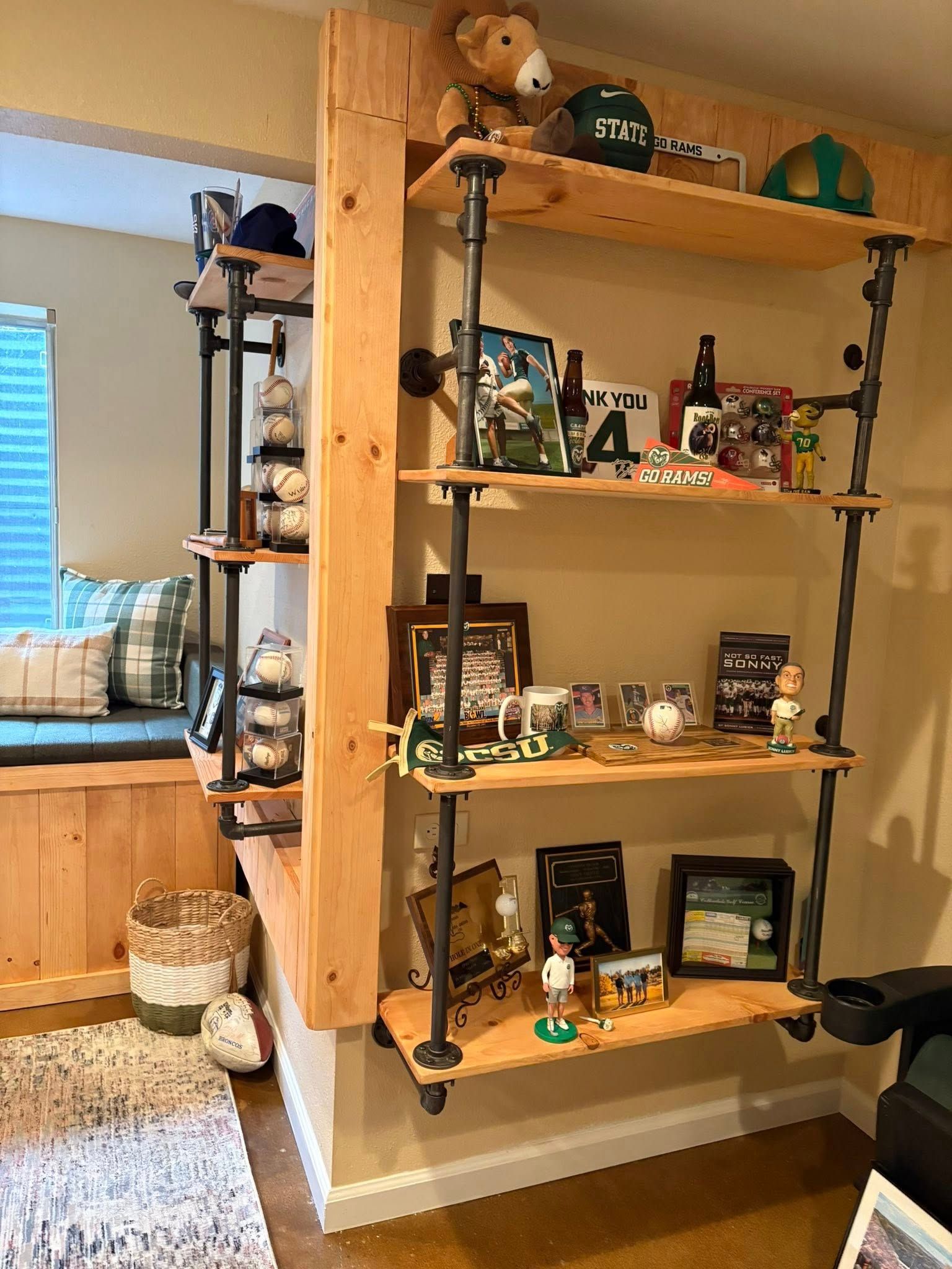 Wooden shelves built into a corner, with sports memorabilia displayed on them.