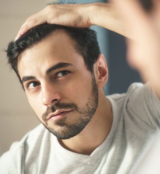 Man Checking His Hair — Troy, MI — Chambers Hair Institute Man Checking His Hair — Troy, MI — Chambers Hair Institute