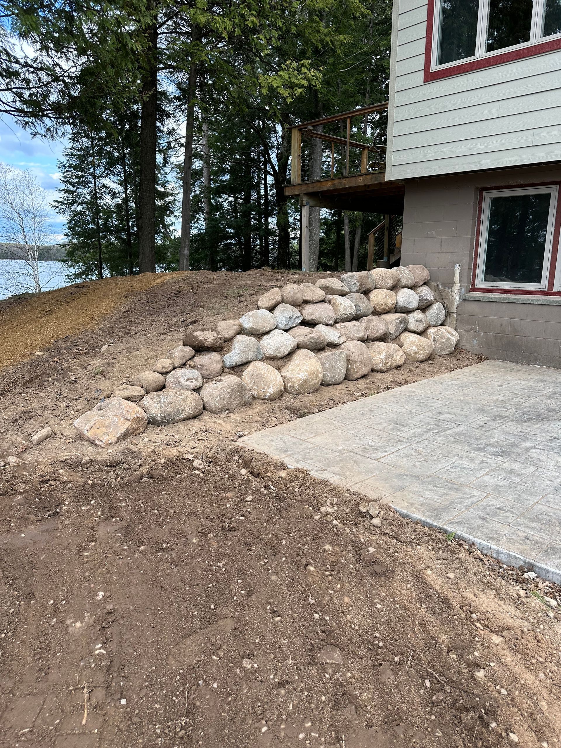 Stone retaining wall next to a house.