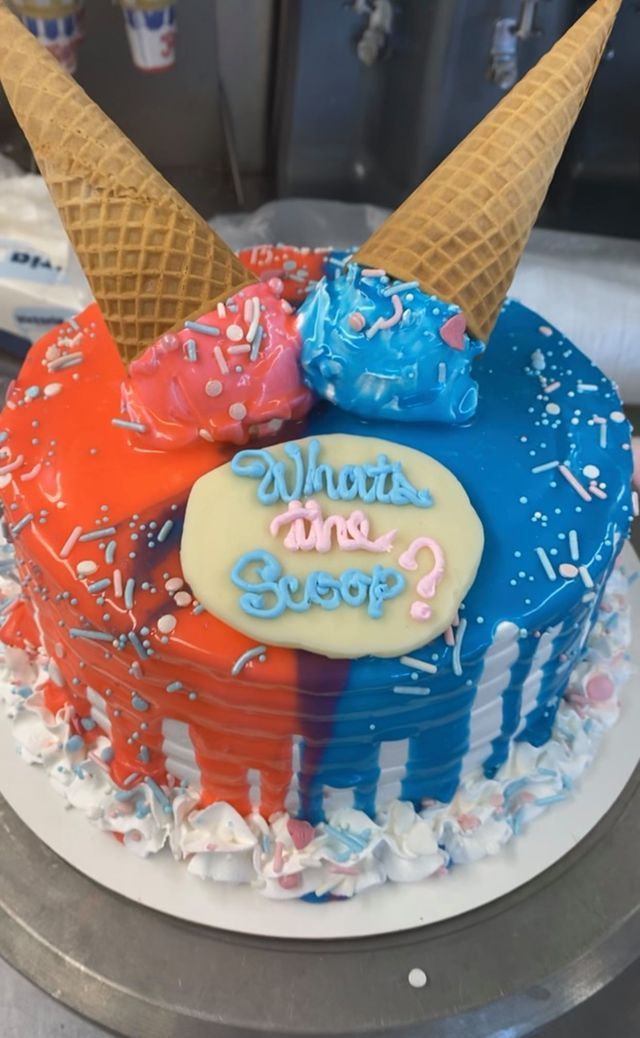 A gender reveal cake with ice cream cones on top