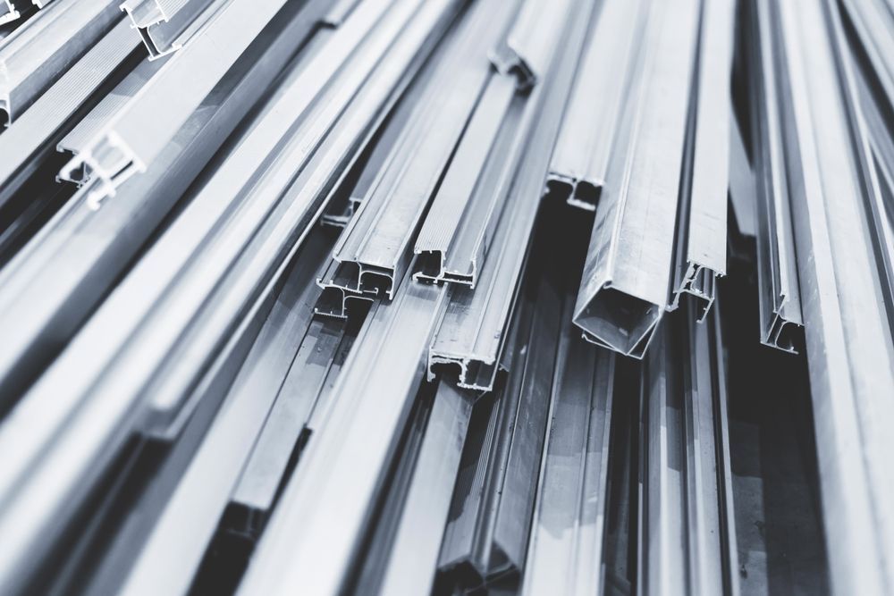 Stacked silver metal beams and channels viewed from above
