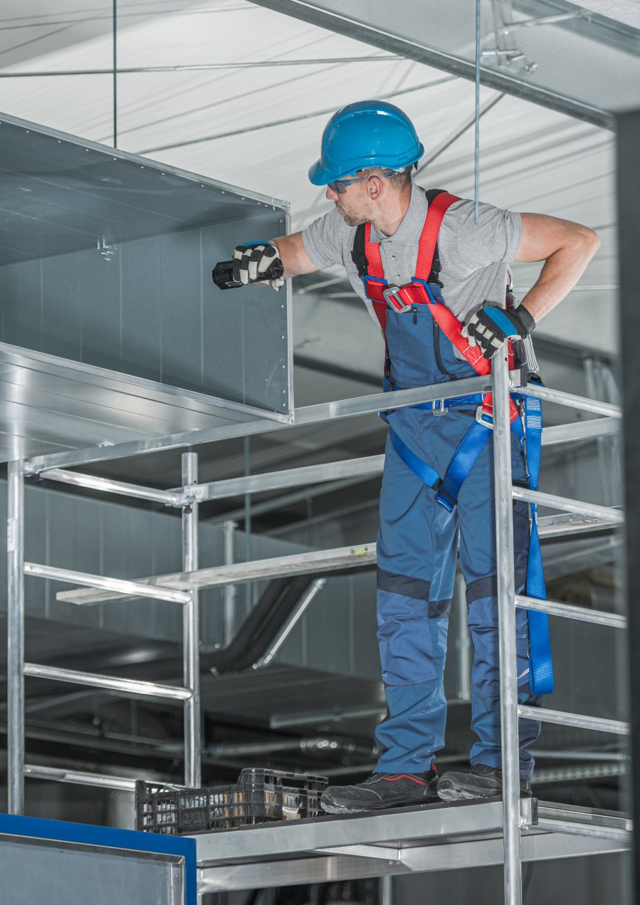 an HVAC worker checking the vents