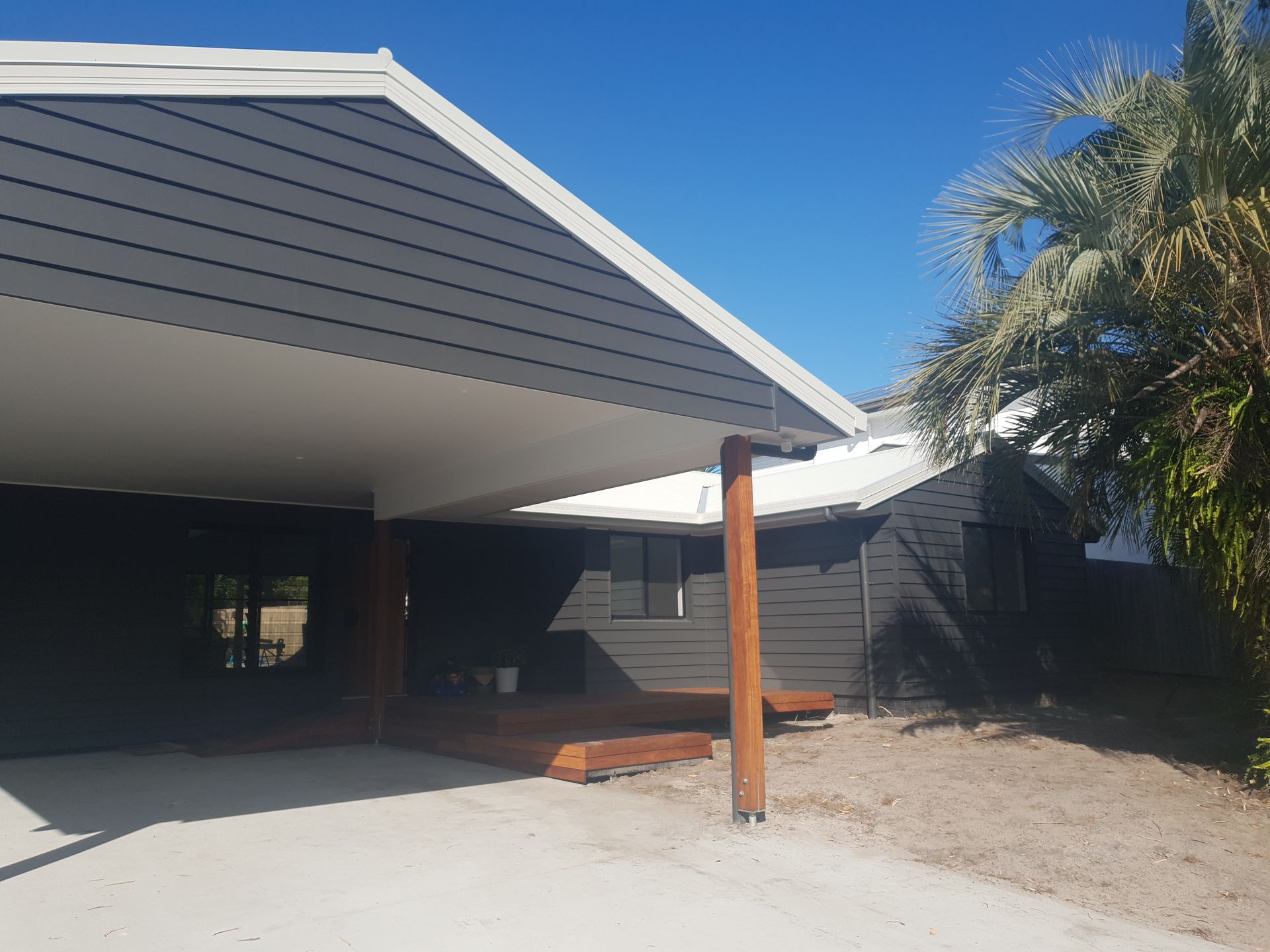 Front Porch of a House With a Slanted Gray Roof, and Wooden Support Post — Greg Pollard Building in Banora Point, NSW