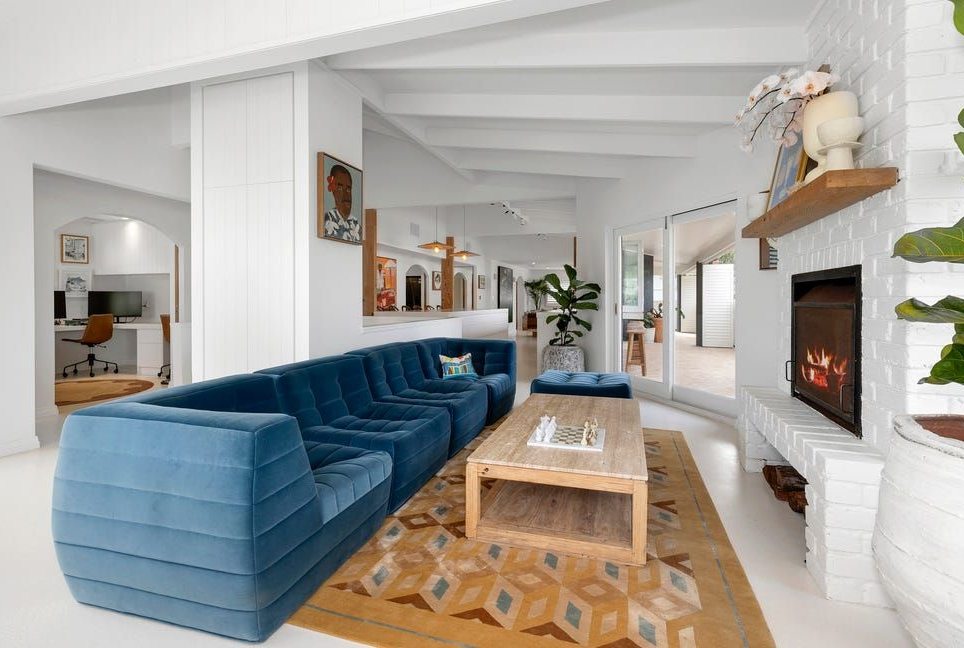 Modern Living Room With Blue Sofa, and White Fireplace With Firelit Insert — Greg Pollard Building in Cabarita Beach, NSW