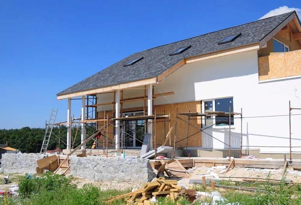 Partially Built House With Scaffolding and Exposed Walls Under a Blue Sky — Greg Pollard Building in Cabarita Beach, NSW