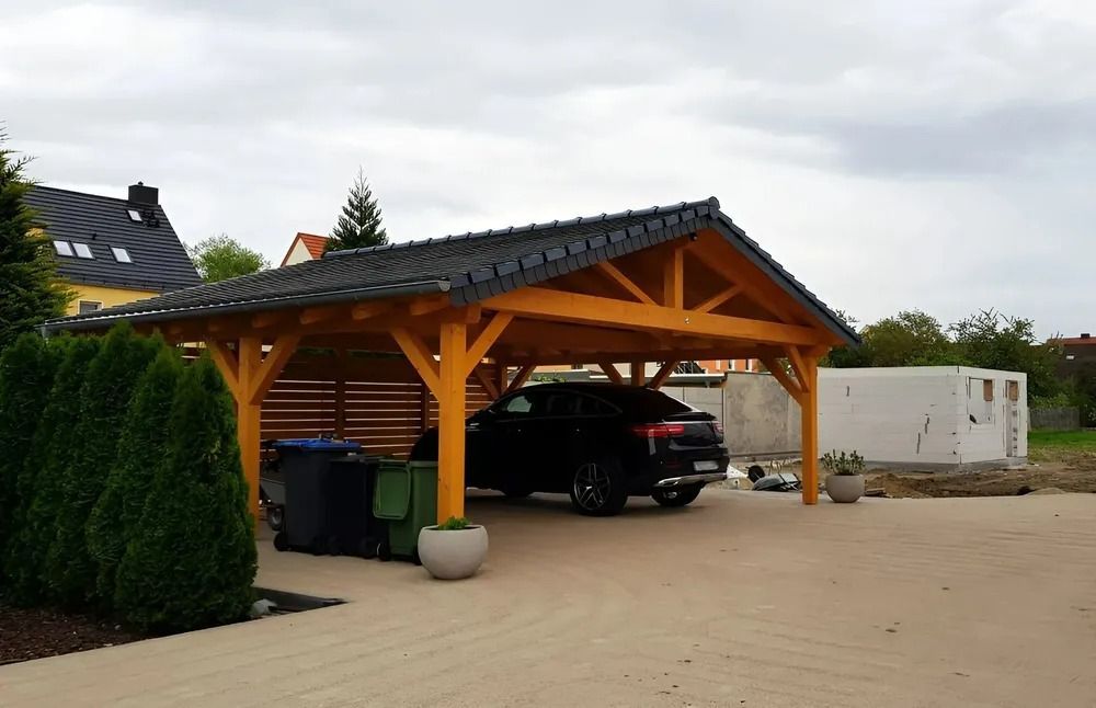 Wooden Carport With a Black SUV Parked Inside on a Paved Driveway, Beside a Hedge and White Trailer — Greg Pollard Building in Cabarita Beach, NSW