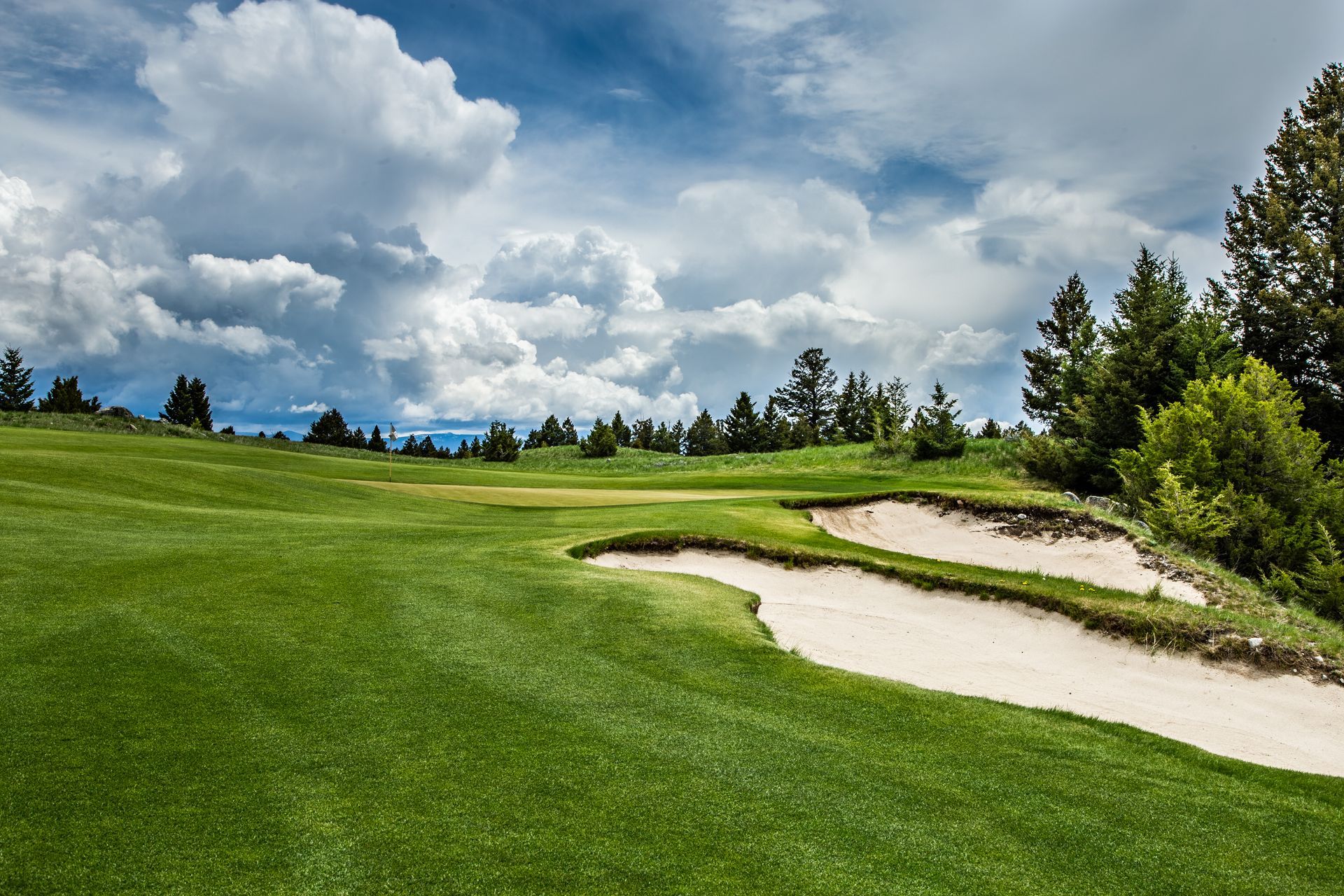 A golf course with a bunker in the middle of it.