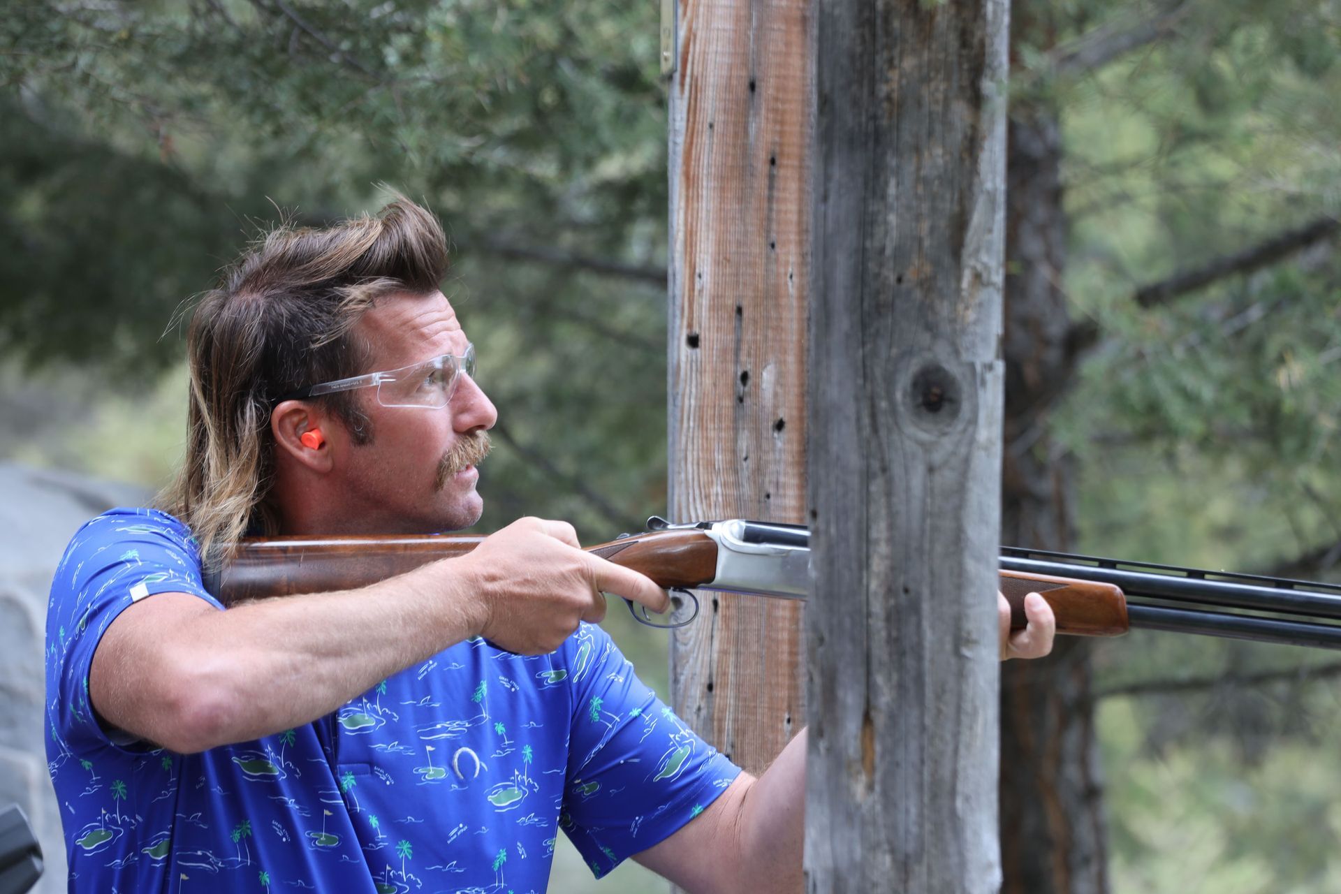 A man lines up to take a shot at a target