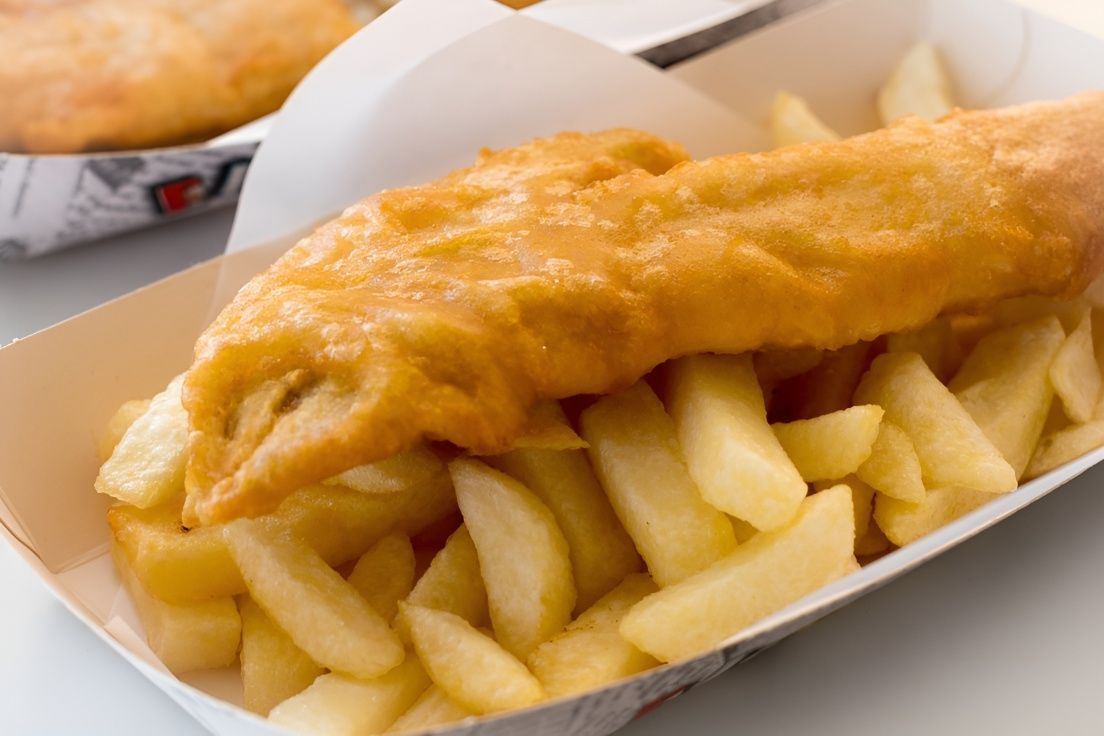 A Tray of Fish and Chips With a Piece of Fish in It — Mulgrave Seafoods In Bungalow, QLD
