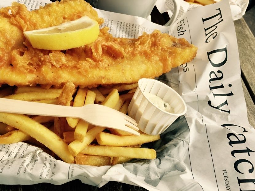 Fish and Chips on a Newspaper That Says the Daily Catch — Mulgrave Seafoods In Earlville, QLD
