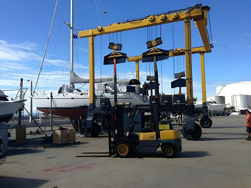 A Forklift is Lifting a Boat in a Marina ā Mackay Marine Services in Mackay, QLD