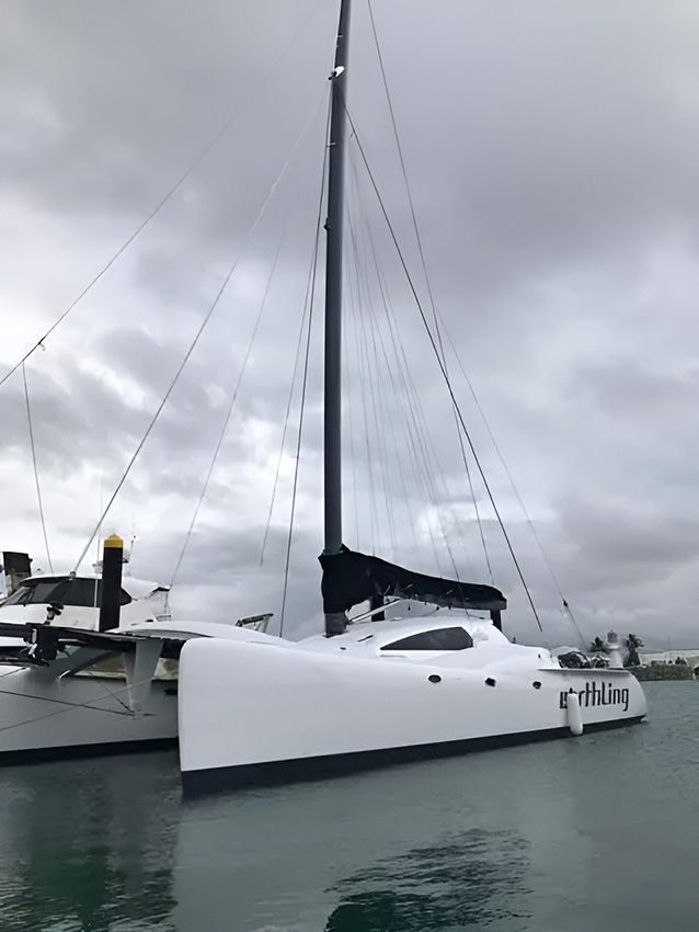 A White Sailboat is Docked in the Water — Mackay Marine Services in Mackay, QLD