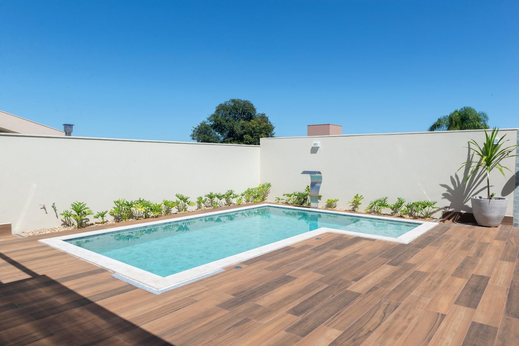 There is a Large Swimming Pool in the Backyard of a House — Sparky Mid North Coast In Forster, NSW