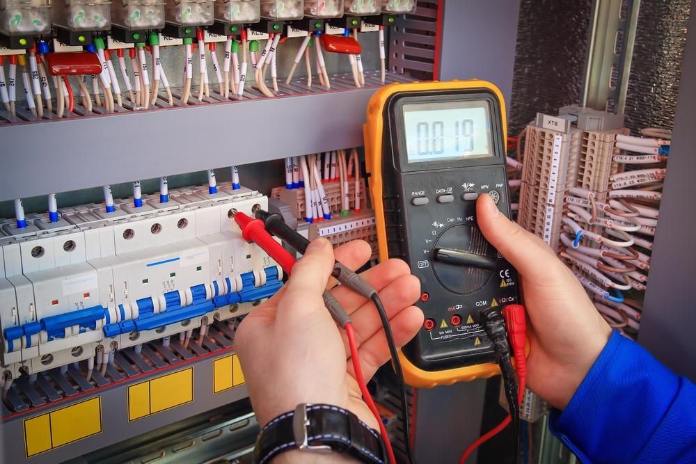 A Person is Using a Multimeter to Test a Circuit Board — Sparky Mid North Coast In Harrington, NSW