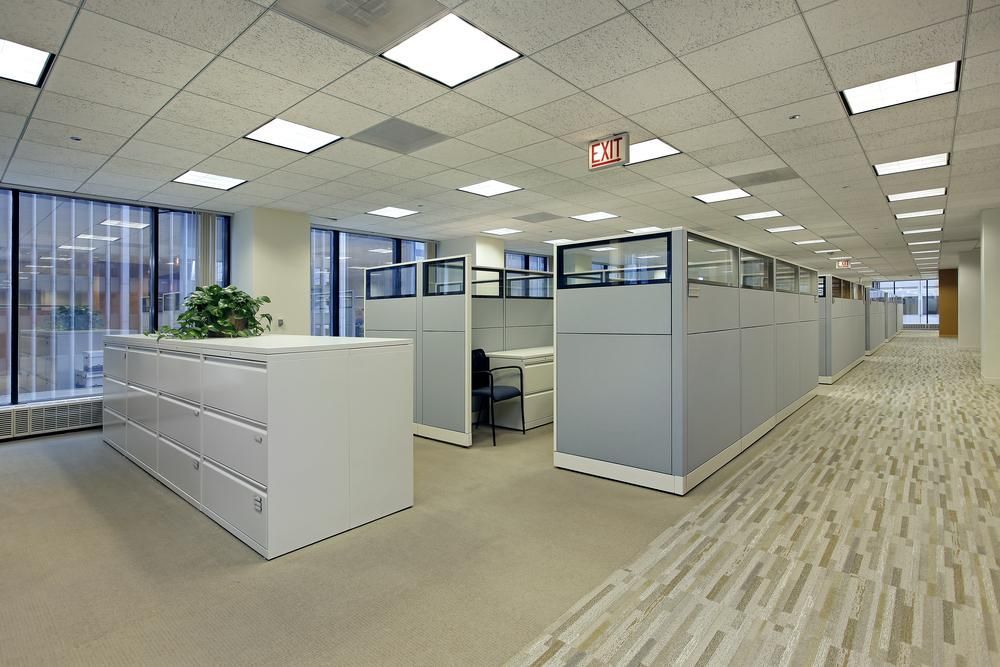 A Large Office With Cubicles and a Red Exit Sign — Sparky Mid North Coast In Forster, NSW
