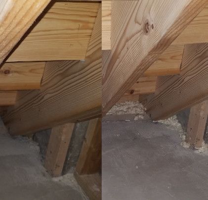 Close-up view of wooden stairs underside, showing support beams and steps within an attic or unfinished space.