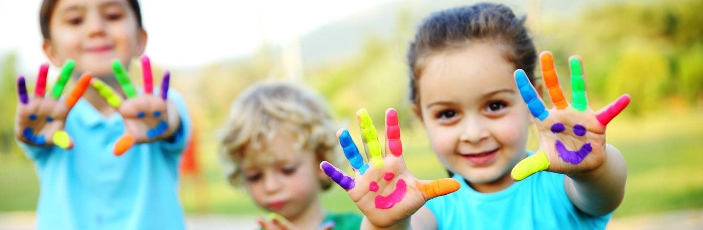 Girl smiling with paint on her hands
