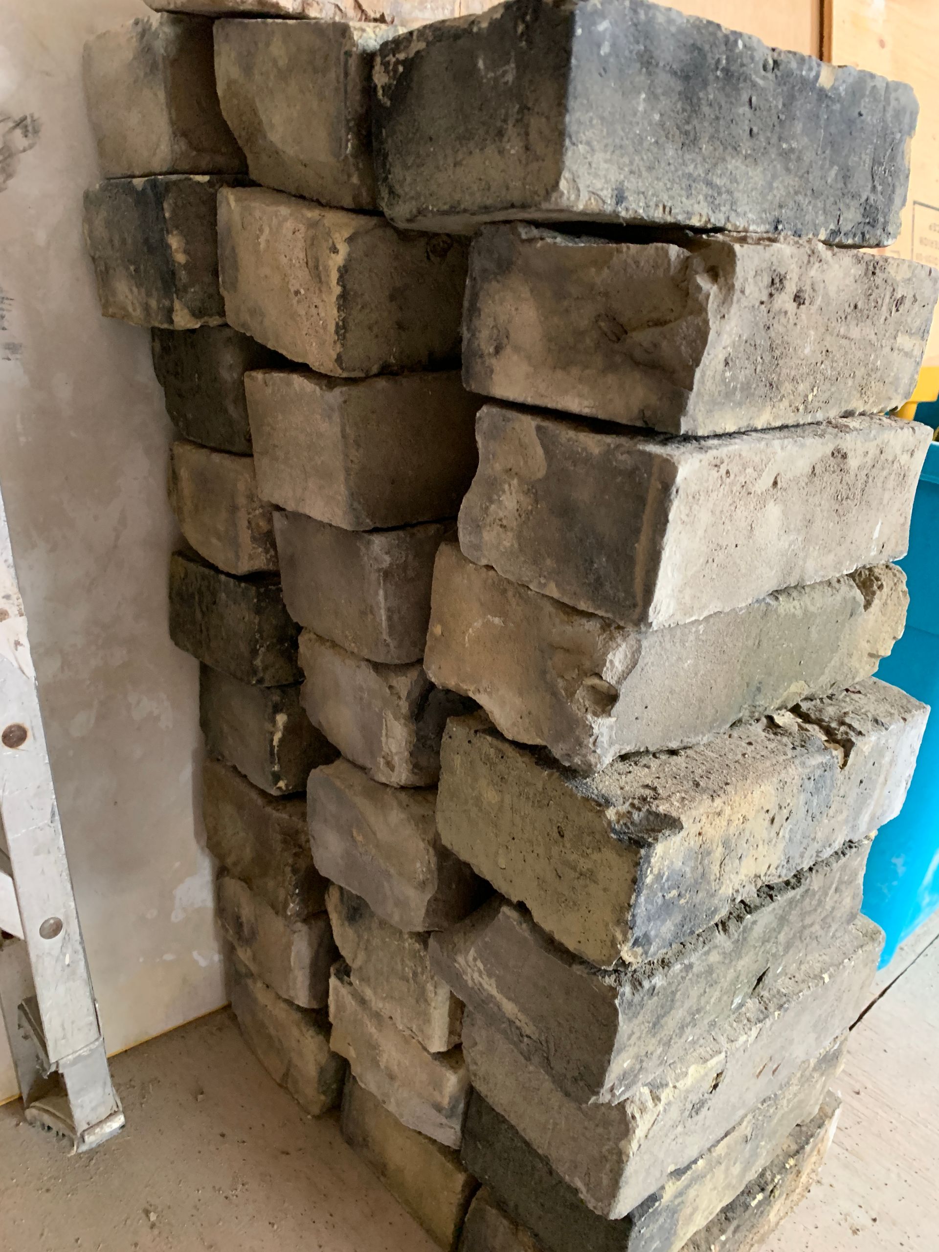 A pile of bricks stacked on top of each other in a room.