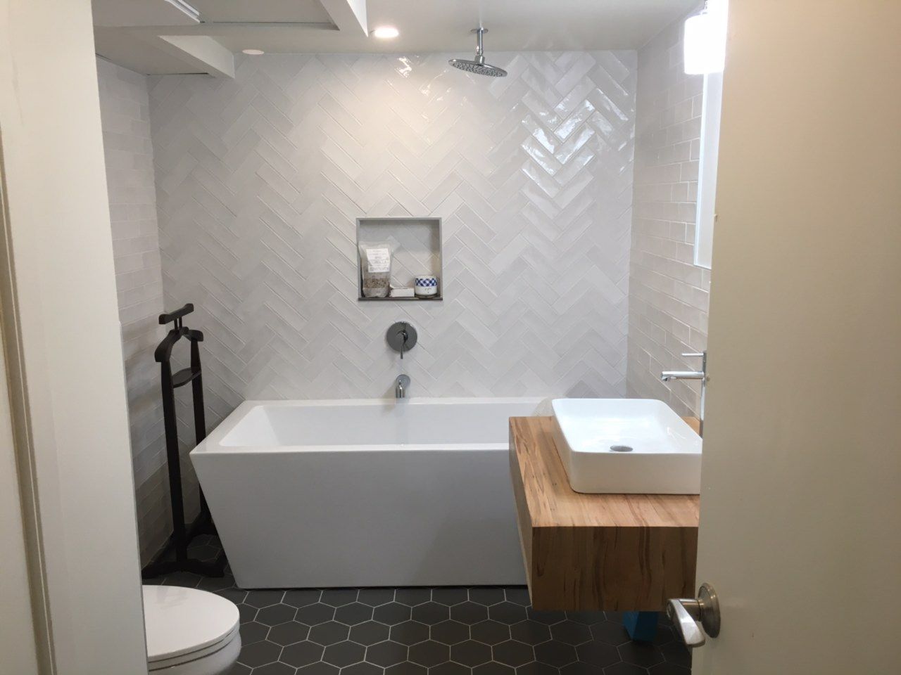 A bathroom with a tub , sink , toilet and shower.