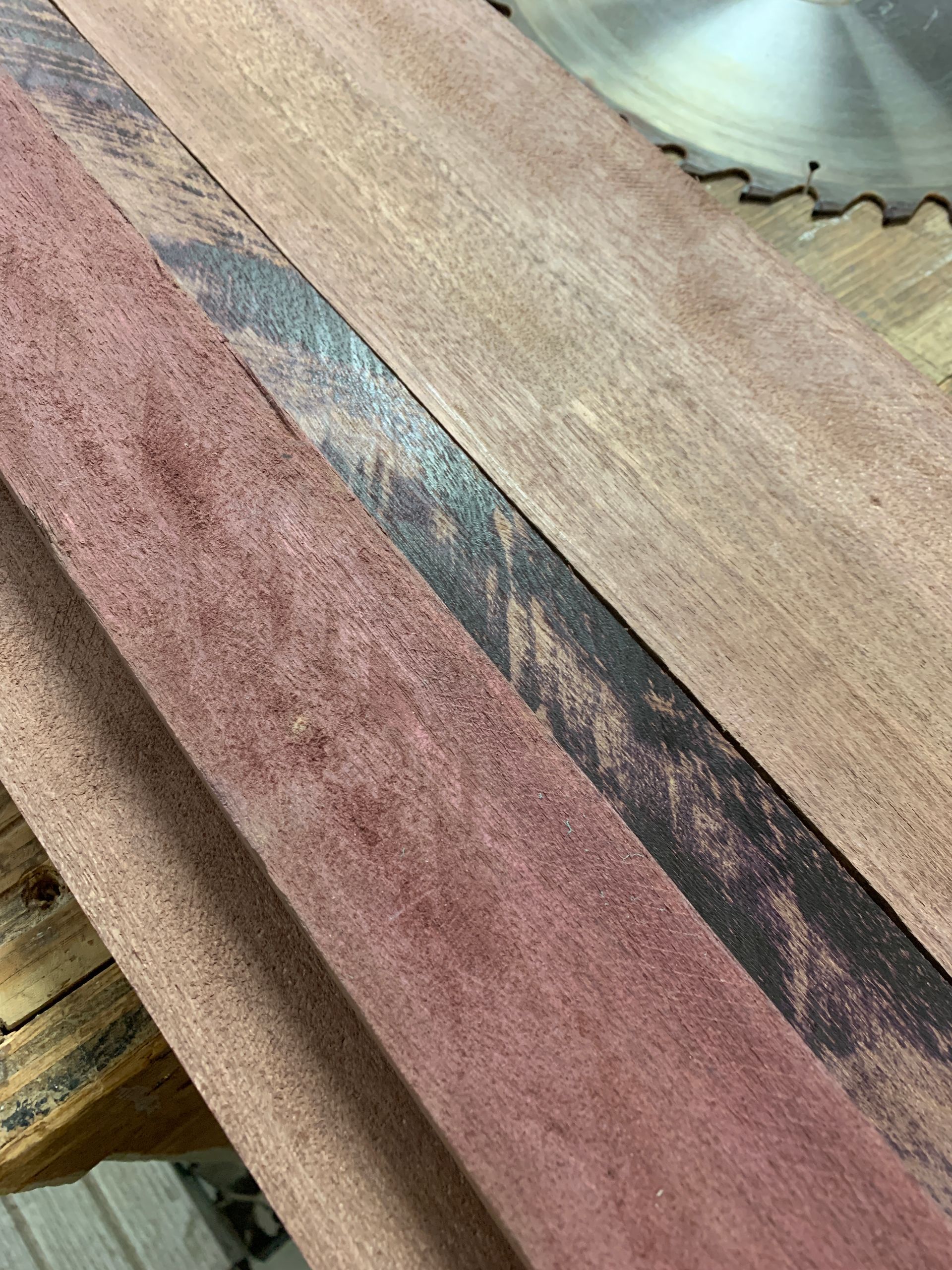 A circular saw is cutting a piece of wood.