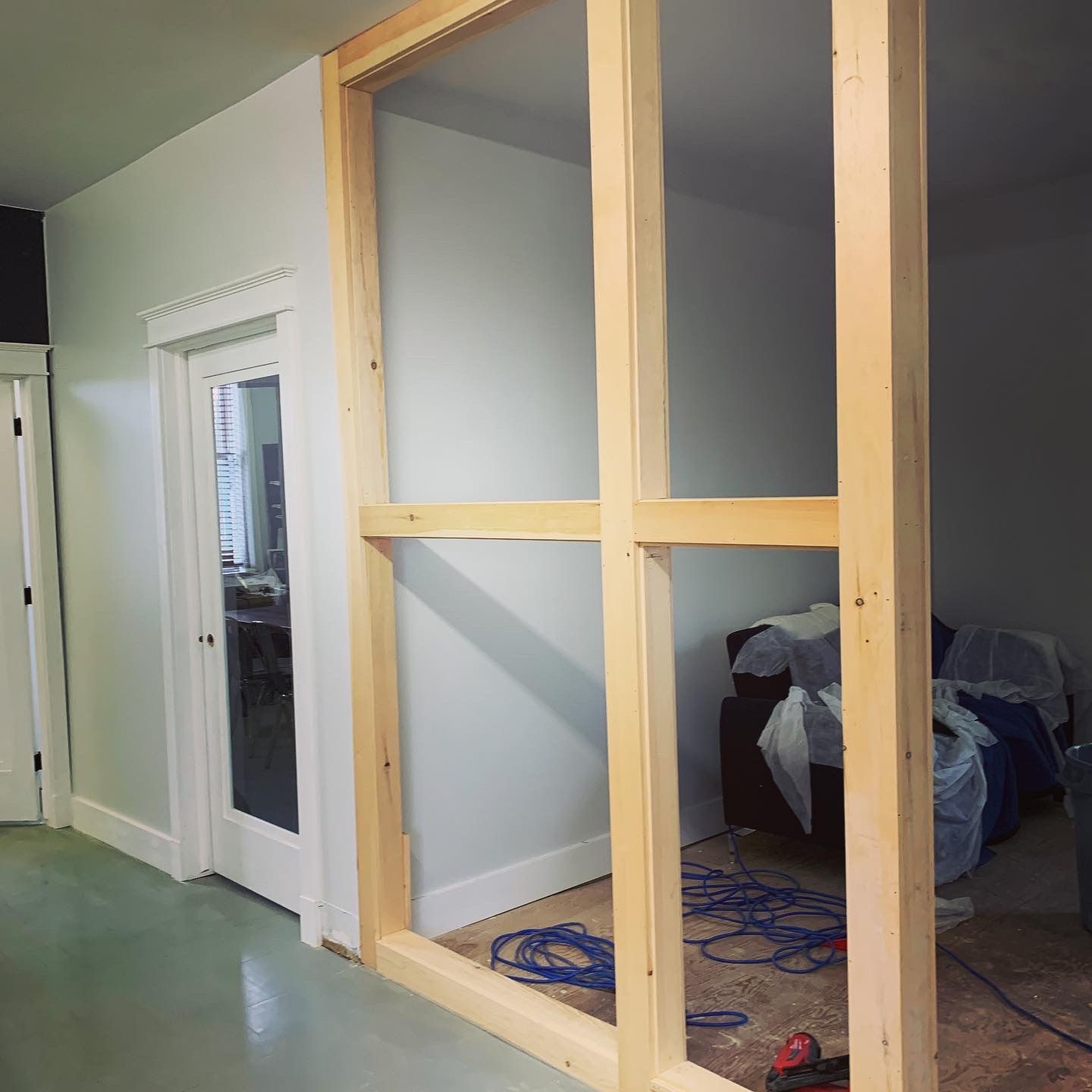A room with a wooden wall and a glass door