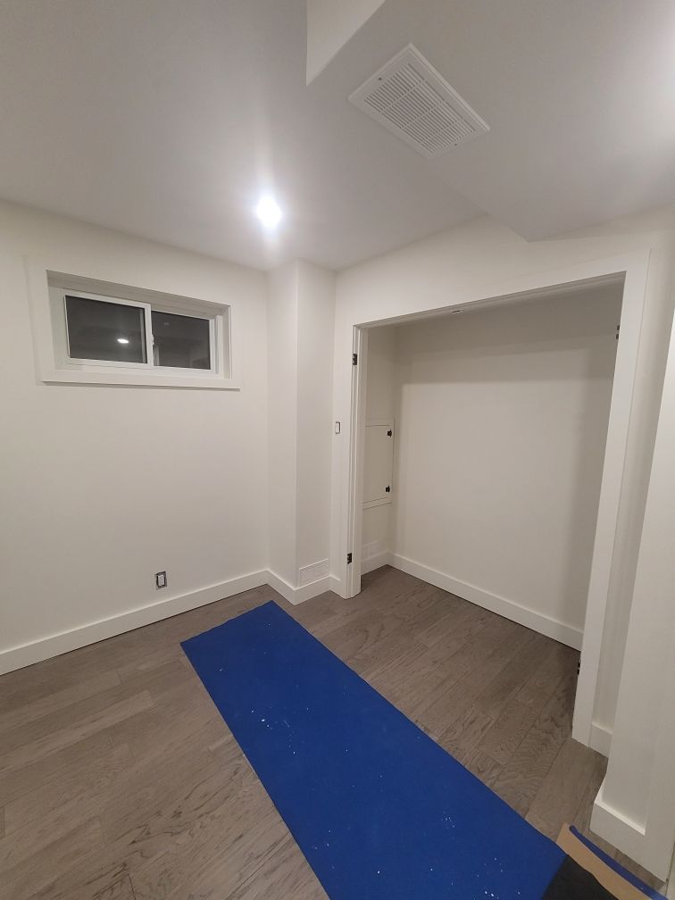 There is a blue yoga mat in the middle of the room.