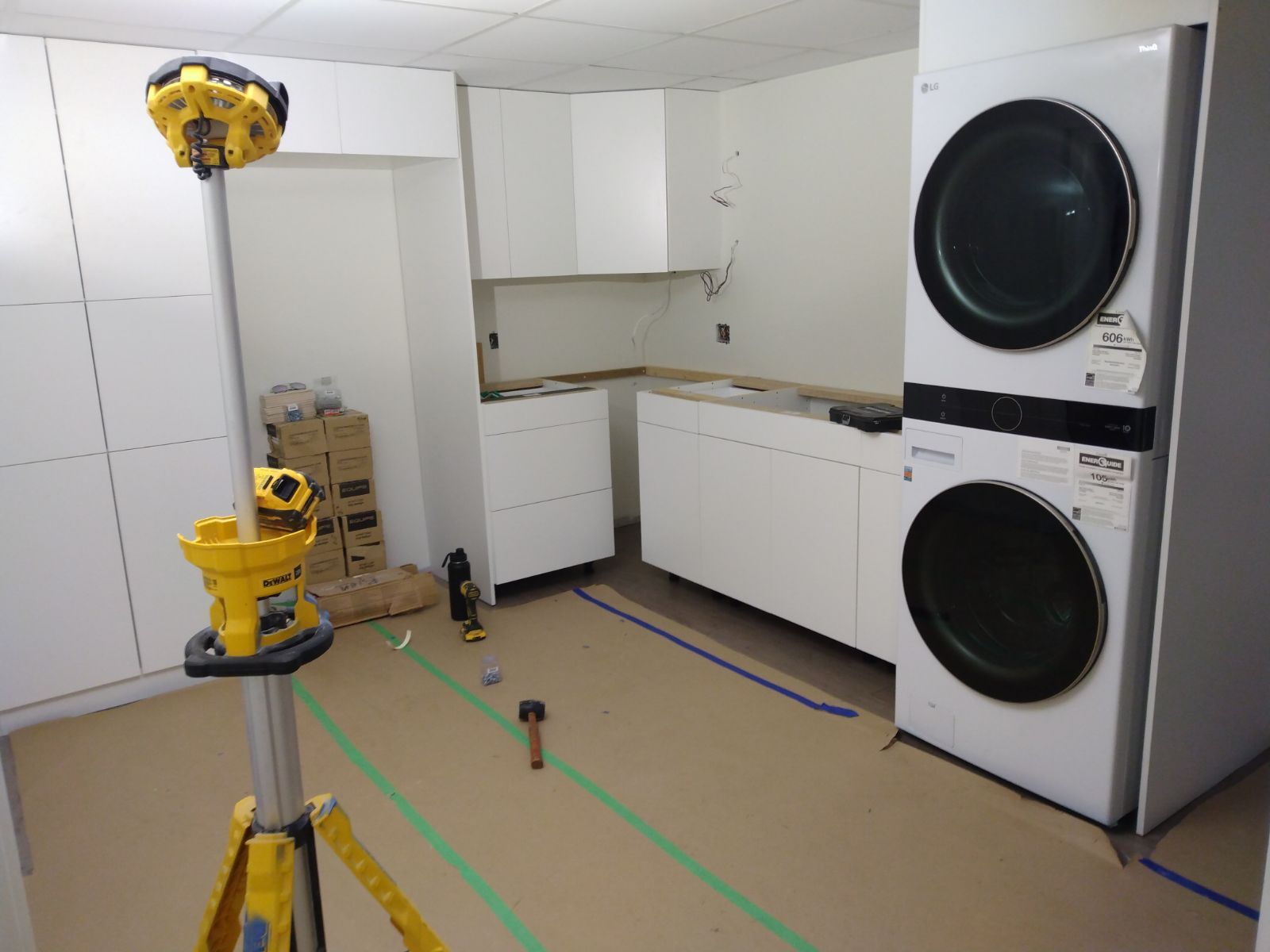 A laundry room with a washer and dryer stacked on top of each other.