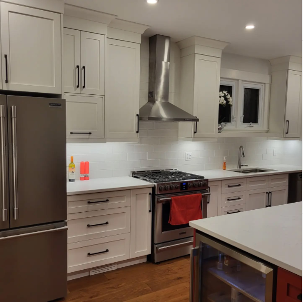 A kitchen with white cabinets and stainless steel appliances