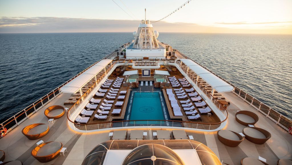 A large cruise ship with a large swimming pool on the deck.