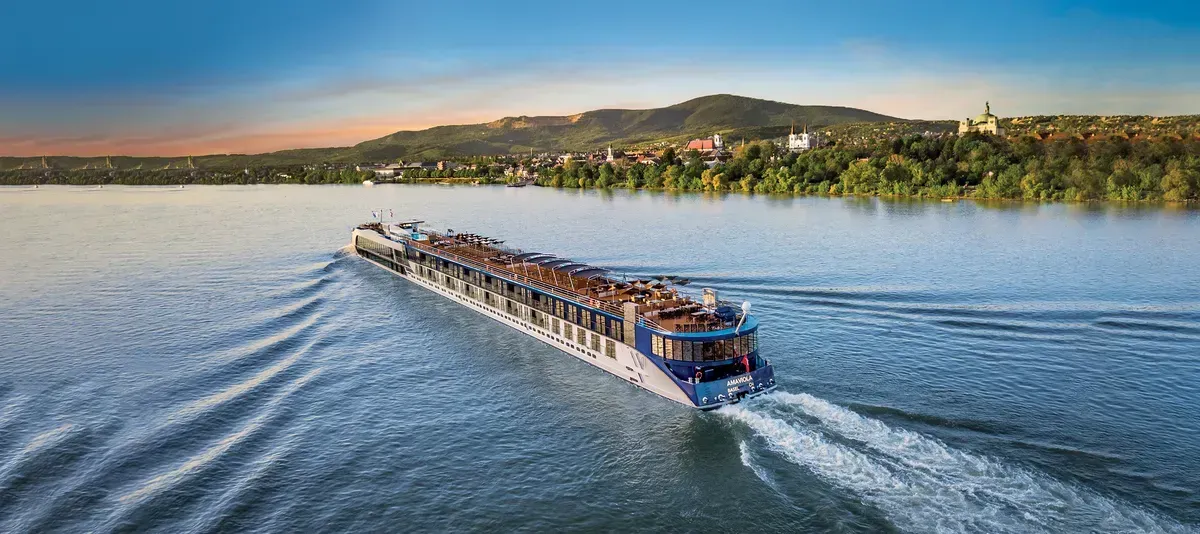 A large cruise ship is floating on top of a large body of water.