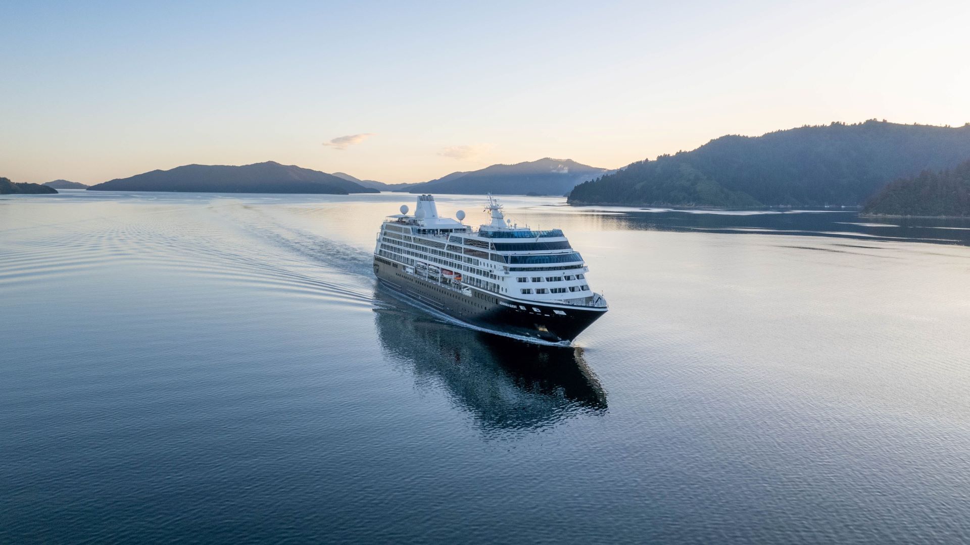 An aerial view of a cruise ship floating on top of a body of water.