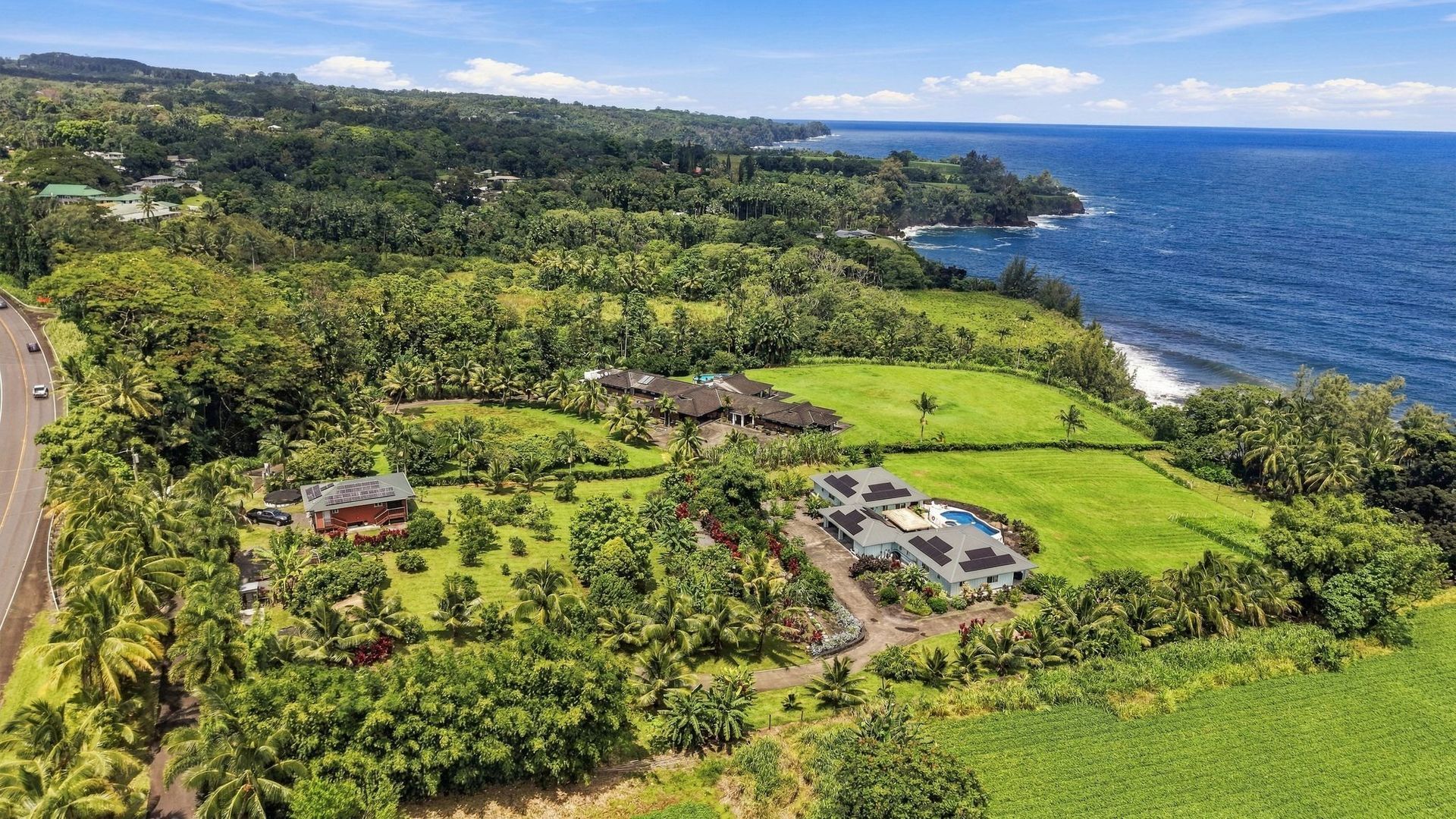 Koili Point’s two homes and orchard above the Pacific on the Hāmākua Coast.