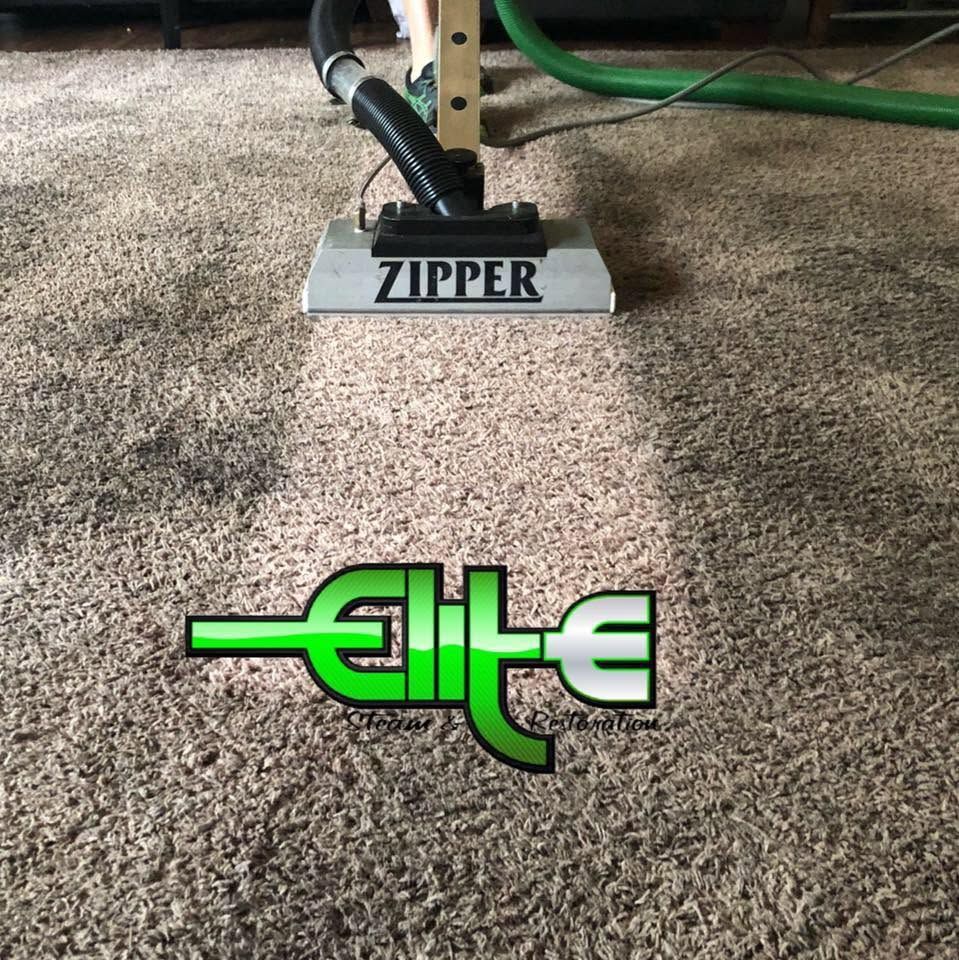 Carpet cleaner labeled “ZIPPER” with green “elite” logo on beige carpet.