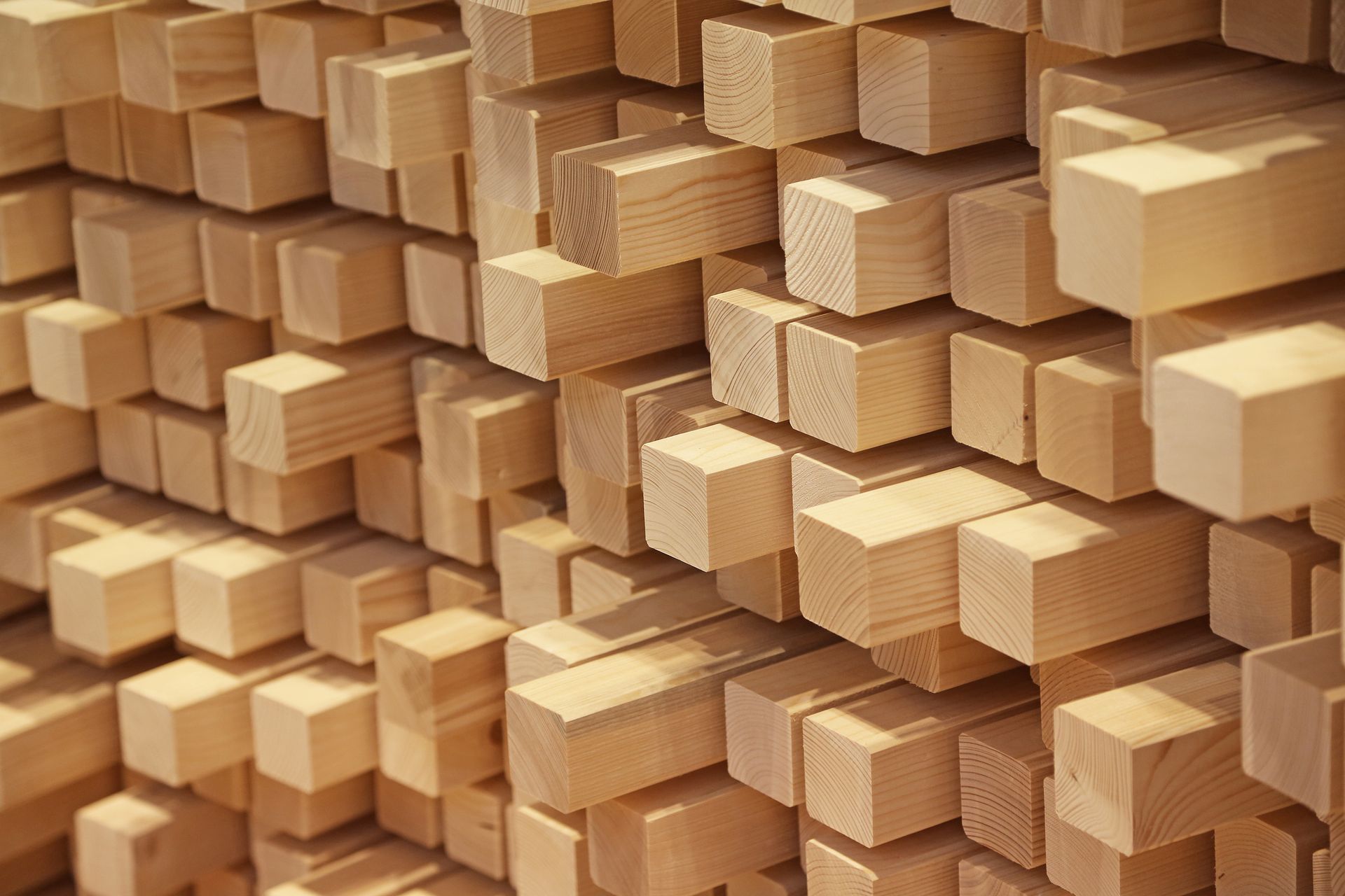 Wooden lumber stacked, showing end grains.