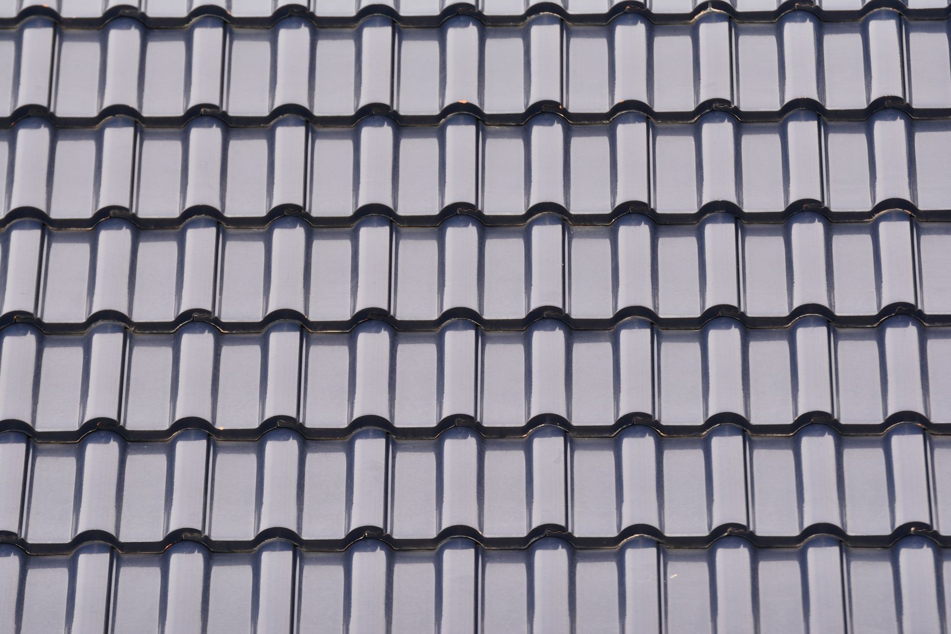 Dark gray roof tiles arranged in rows.