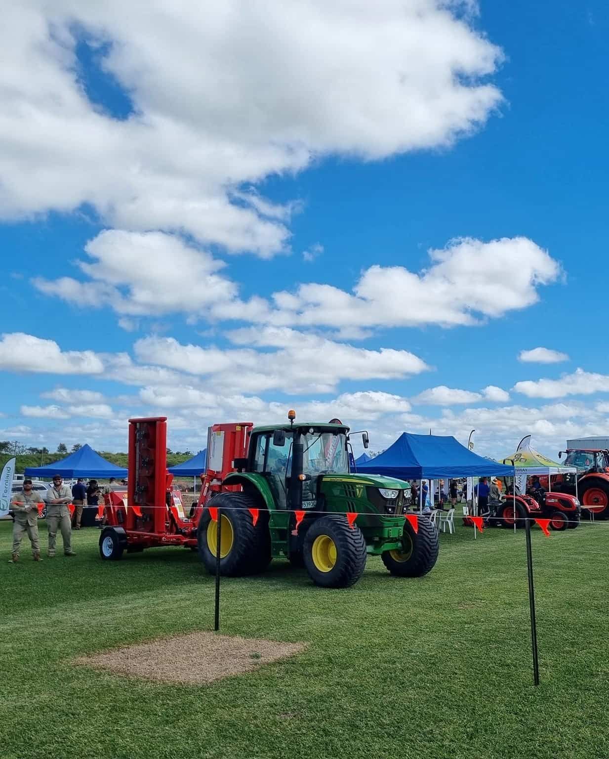 A Green John Deere Tractor Is Parked In A Grassy Field — Marian Lawns In Cannonvale, QLD