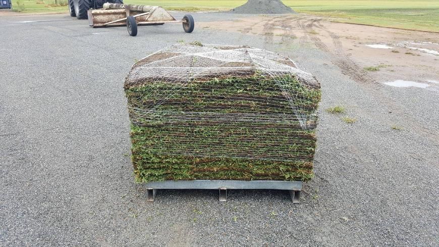 A Large Stack Of Grass Is Wrapped In Plastic — Marian Lawns In Moranbah, QLD