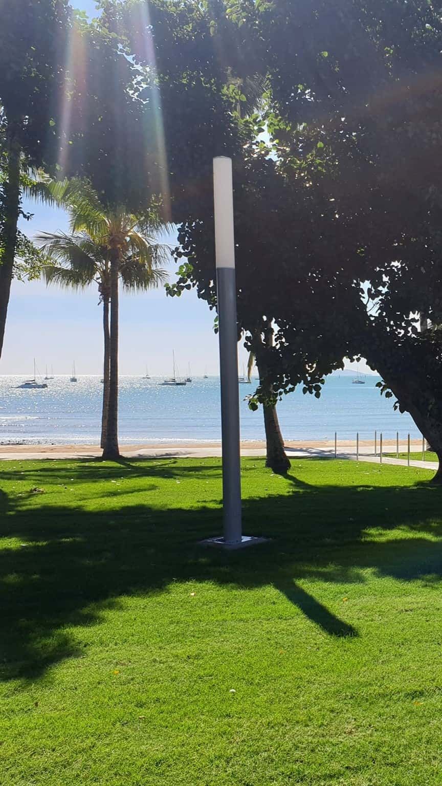 A Park With Trees And A Beach In The Background — Marian Lawns In Moranbah, QLD