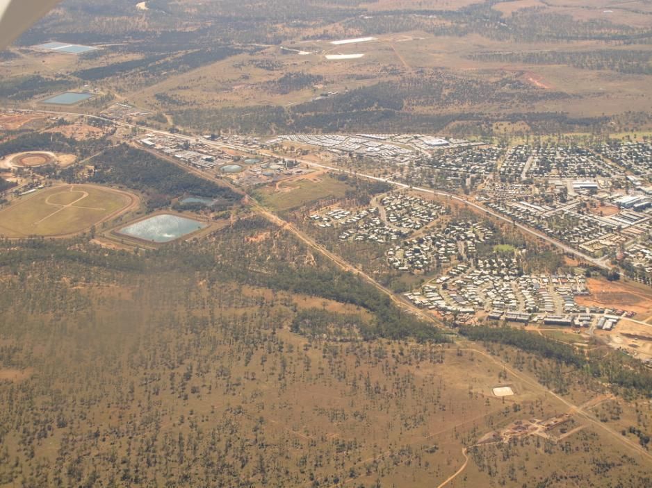 An Aerial View Of A Small Town In The Middle Of A Desert — Marian Lawns In Moranbah, QLD