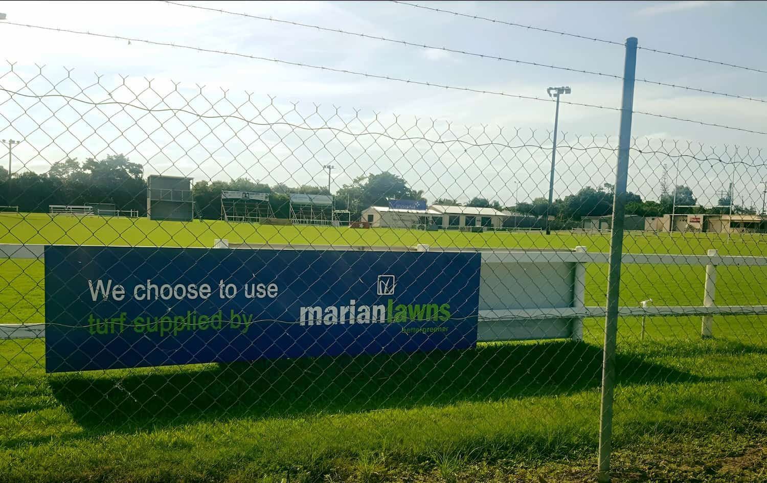 A Sign Behind A Chain Link Fence Says We Choose To Use Marian Lawns — Marian Lawns In Bowen, QLD