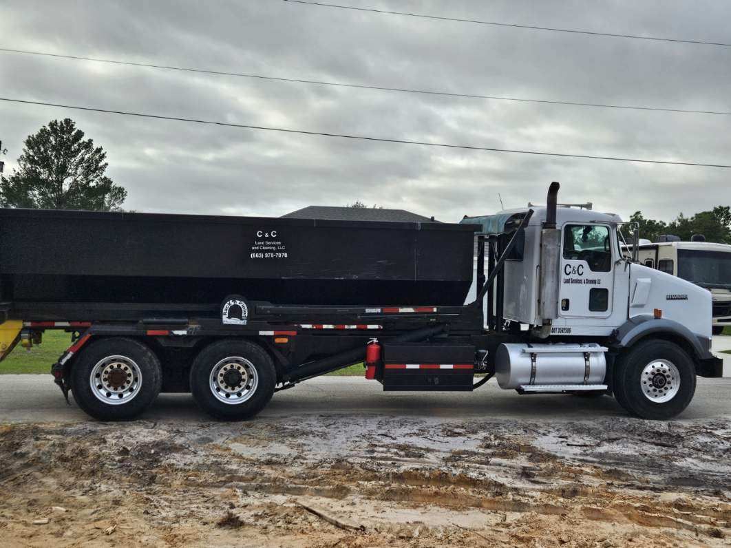 A dump truck is parked on the side of the road.